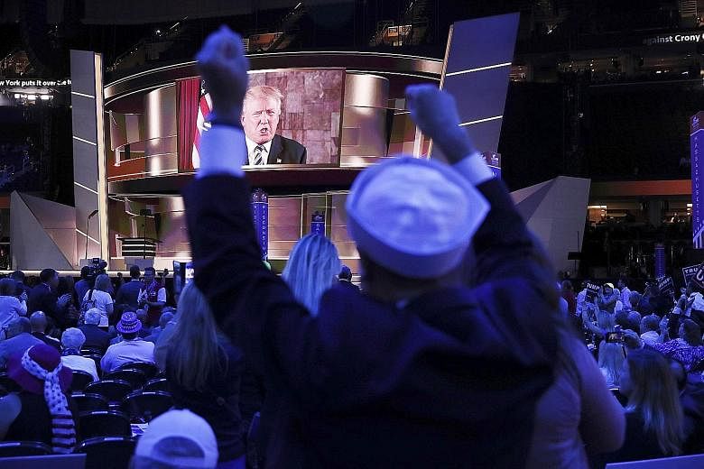 People cheering as Mr Trump delivered a live video message for his supporters on the second day of the Republican National Convention in Cleveland on Tuesday.