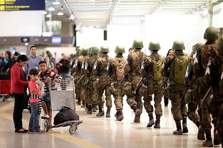 Soldiers patrolling the international airport in Rio de Janeiro on Tuesday. A presumed Brazilian Islamist group has pledged allegiance to ISIS.
