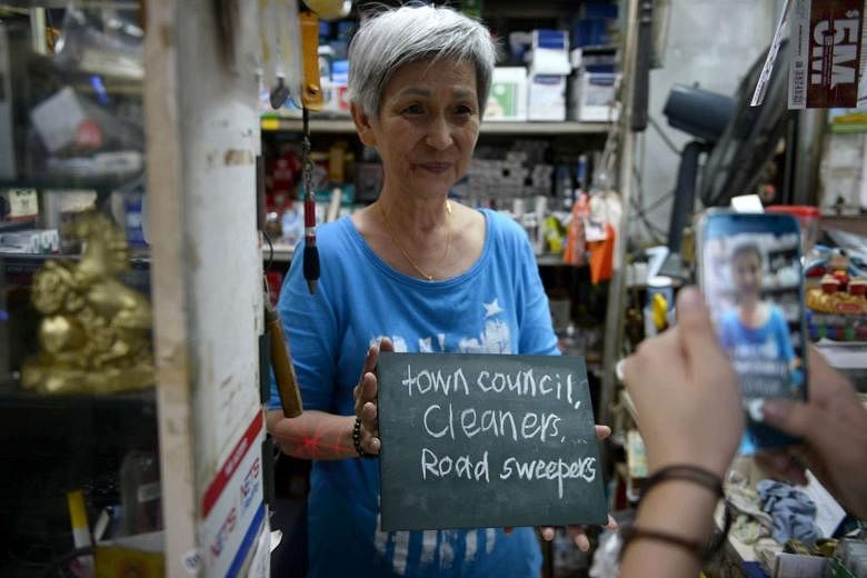 Provision shop owner Ong Siew Hong expressing her thanks to cleaners and road sweepers. 