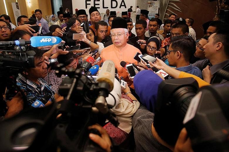 Malaysian Prime Minister Najib Razak speaking to journalists in Kuala Lumpur yesterday. He has said that those named in the suits, including his stepson Riza Aziz, have the right to legal process in the United States.