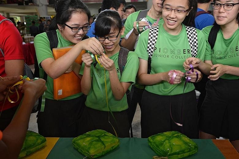 Students and staff from Pioneer Junior College marked Racial Harmony Day yesterday with cultural activities like weaving ketupat packets. The annual event was celebrated in many primary and secondary schools.