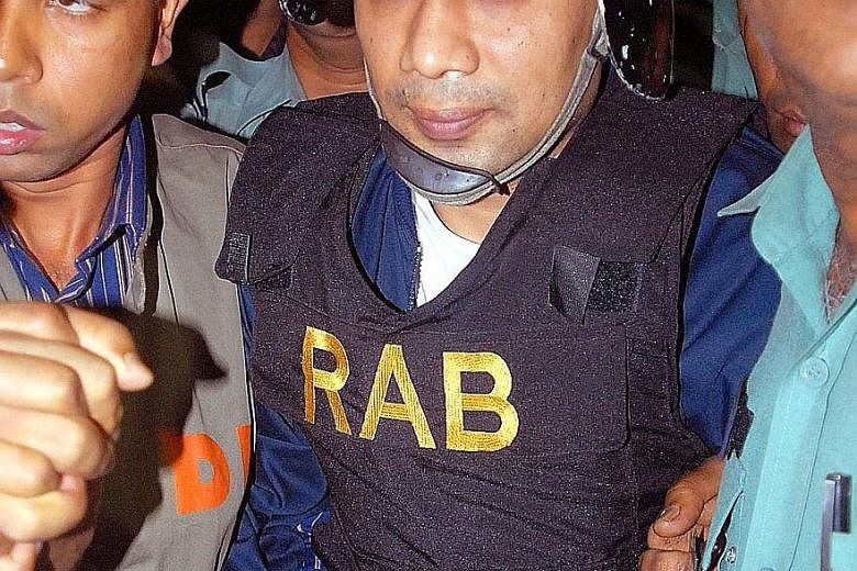Tarique Rahman being escorted to court in 2007. He was convicted in absentia for money laundering and fined $3.4 million.