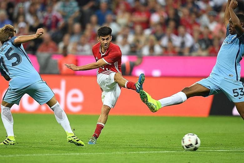 Hosts Bayern Munich's Erdal Ozturk (centre) scoring the goal that condemned Pep Guardiola to a loss in his first match as Manchester City manager. City will also play pre-season friendlies against Manchester United, Borussia Dortmund and Arsenal.
