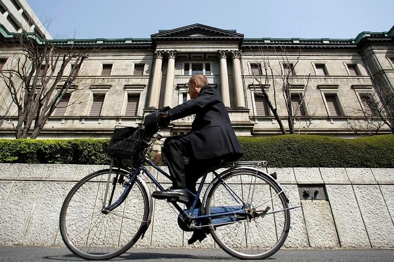 The Bank of Japan building in Tokyo. A Reuters poll showed 85 per cent of analysts expect the Japanese central bank to ease on Friday next week. The BOJ has already implemented negative interest rates and is printing 80 trillion yen (S$1 trillion) a 