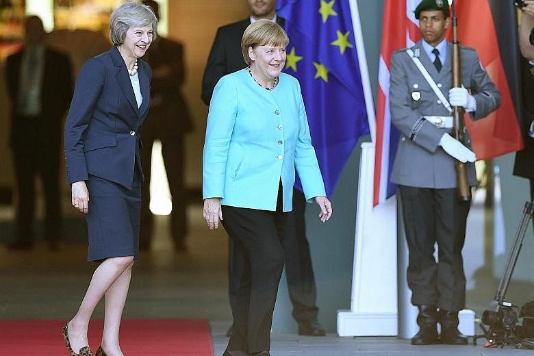 British PM Theresa May (left) with German Chancellor Angela Merkel in Berlin. ST is holding a briefing on Aug 17 in which the outlook and impact of Brexit will be discussed, as well as Britain's economic prospects.