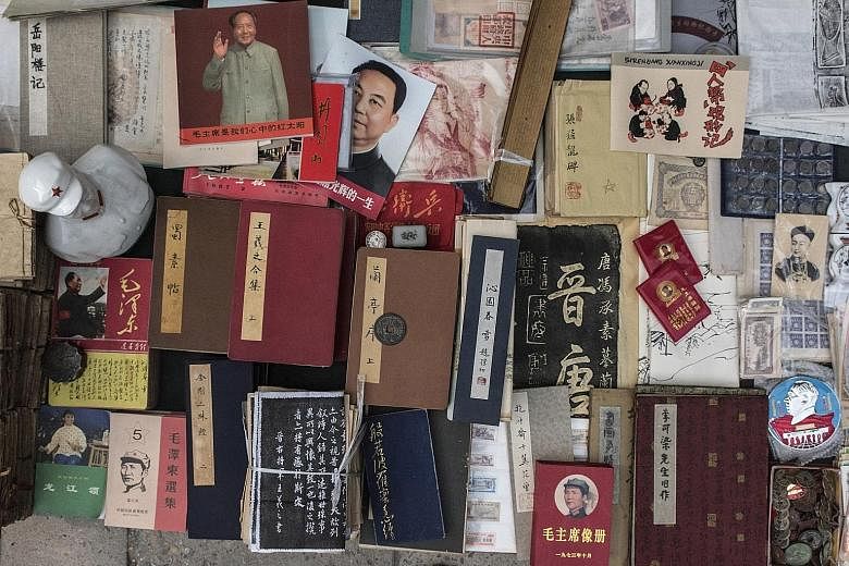 Books, coins and Mao-era objects on display at the Panjiayuan Antique Market in Beijing earlier this month. Collectors of rare books and posters find gems in Panjiayuan's ramshackle alleyways, or make discoveries in its more exclusive little shops.