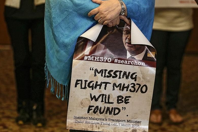 The wife of an MH370 crew member at a press conference ahead of the MH370 Ministerial Tripartite Meeting in Kuala Lumpur yesterday. The plane vanished on March 8, 2014 with 239 people on board