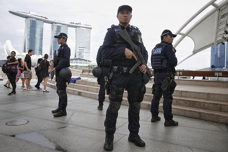 Officers of the new Emergency Response Teams on patrol at the Esplanade area yesterday. Since last month, these ERT officers, who are specially trained in counter-assault skills and armed with HK-MP 5 submachine guns, have been patrolling public area