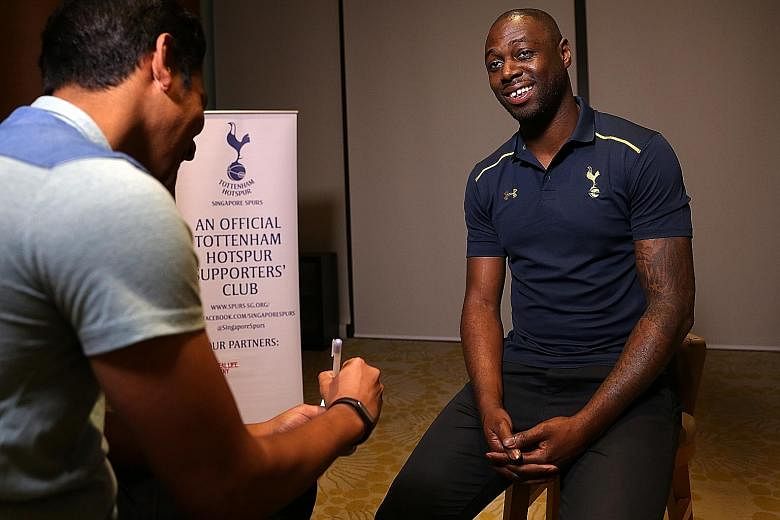 From top: Former England and Tottenham defender Ledley King at a function at the Ramada Singapore hotel yesterday. He endorsed the Three Lions' new boss Sam Allardyce as "a forward-thinking manager". King autographing an old Spurs jersey for Singapor