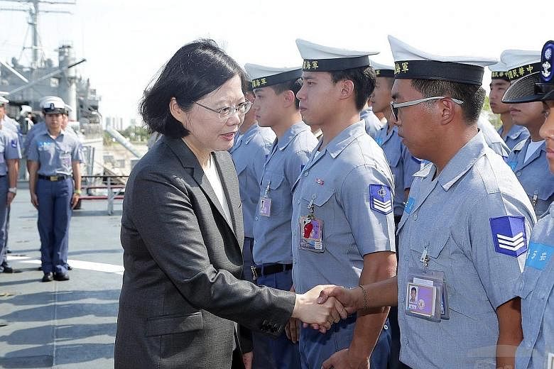 Taiwanese President Tsai Ing-wen on a warship on July 13 before it sailed to the South China Sea on a patrol mission. China said that peaceful ties can be guaranteed only by upholding the "one China" principle.