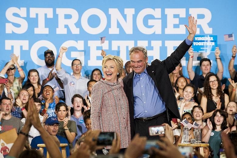 Mrs Clinton campaigning with Mr Kaine in Virginia earlier this month. The presumptive Democratic nominee for the US presidency has chosen Mr Kaine as her running mate, praising the Virginia senator as a "lifelong fighter for progressive causes".