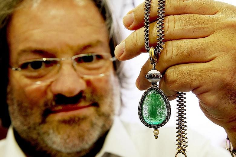 Mr Sciaguato holding up the 55-carat emerald pendant which was a gift from Napoleon III to his lover, the Countess of Castiglione.