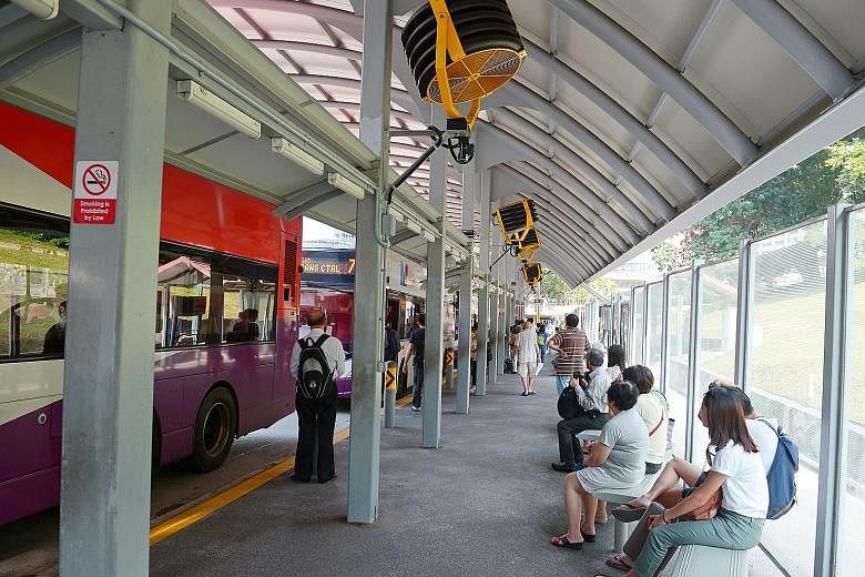 Fans on trial at an Ang Mo Kio bus stop. They can be activated using switches, and will be powered to run for 15 minutes at a time.