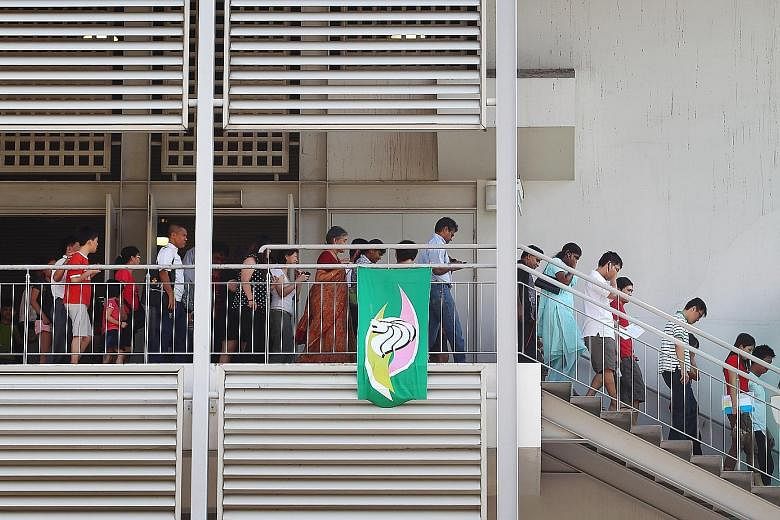 Parents leaving a school hall after a Primary 1 balloting exercise. The study, done by two Raffles Institution alumni last year, showed that better primary schools tend to be located in more affluent estates.