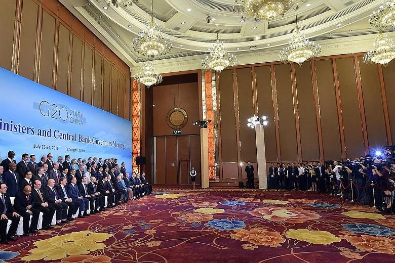 G-20 finance ministers and central bankers in Chengdu, China, yesterday. Singapore's Coordinating Minister for Economic and Social Policies Tharman Shanmugaratnam (far left, middle row) was among those attending the meeting.