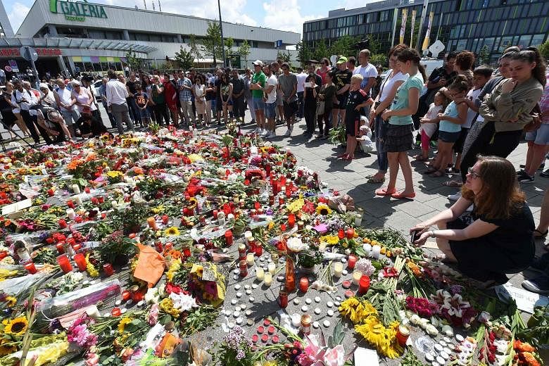 Candles and flowers left yesterday at a makeshift memorial at the Olympia shopping centre in the German city of Munich to remember the nine victims of a shooting rampage last Friday. Officials said the 18-year-old gunman had been planning his crime f