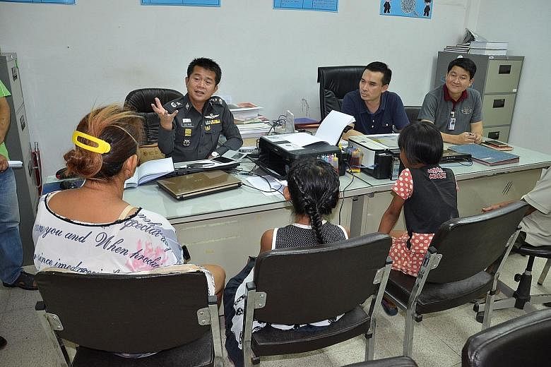 The two girls appearing before Thai police. Officers said rules required charges to be filed even though the girls will not be punished.