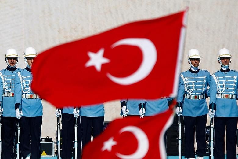 Presidential guardsmen at a rally to mark the 563rd anniversary of the conquest of Istanbul by Ottoman Turks in May this year. Of the regiment's 2,500 members, 300 were arrested over suspected links to last week's failed coup. Figures close to Mr Fet