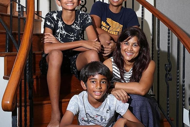 Mrs Denise Ponnampalam-Vijayan with her son Divyan Luke Vijayan, 15 (top left), who had been exempted from taking Chinese. With them are another two of her children, Ashwin Mark Vijayan (in navy blue), 17, and Nishanth John Vijayan, 11.