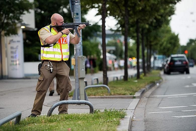 A policeman securing an area after a shooting spree at a shopping centre in Munich last Friday.
