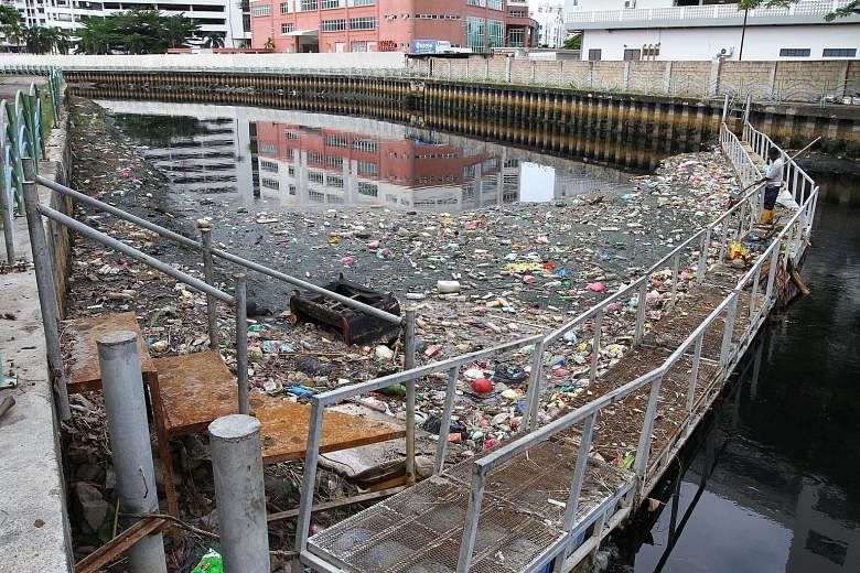 Garbage trapped by the log boom in Sungai Pinang in Jalan Sungai, Penang. A government spokesman said many take the easy way out by dumping everything into rivers, even though they know very well that this will pollute the waterways. Contract workers