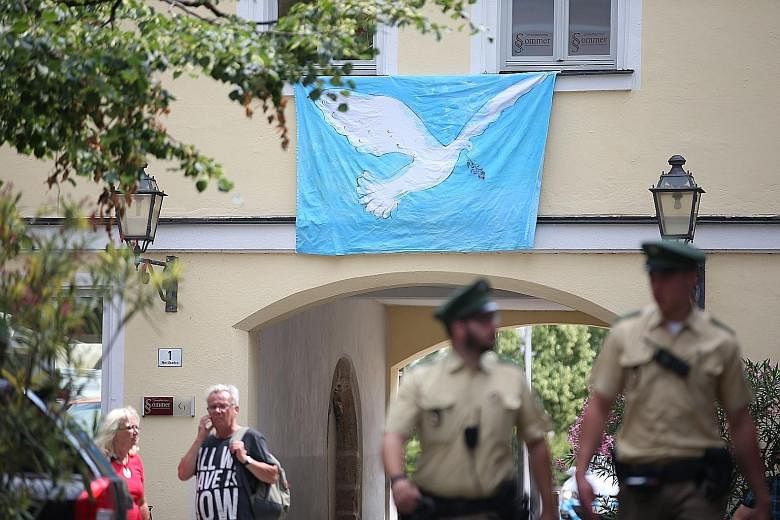The man alleged to be Mohammad Daleel, the Syrian asylum seeker who detonated a bomb near the music festival in the German city of Ansbach. A banner depicting a peace dove in Ansbach, southern Germany, at the site where a Syrian blew himself up tryin