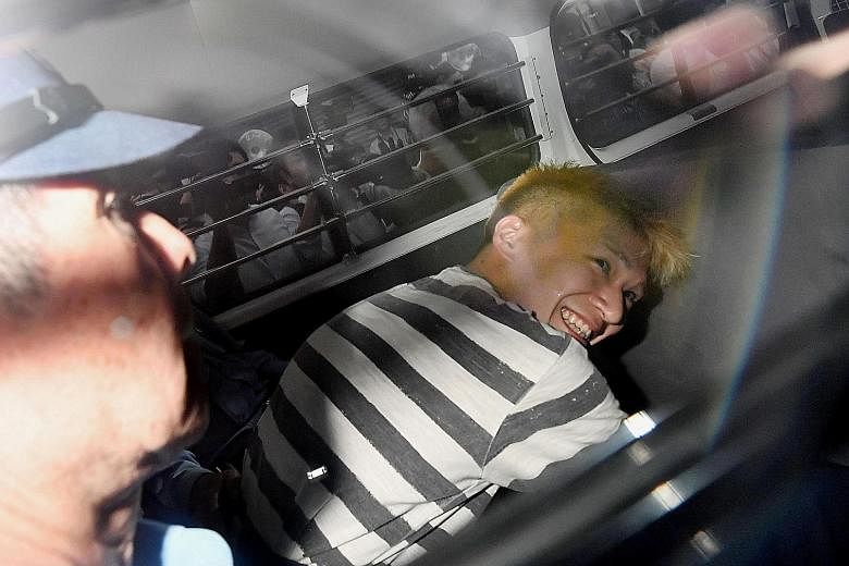 Uematsu smiling broadly as he sat inside a police vehicle, in this picture taken by Kyodo news agency yesterday.