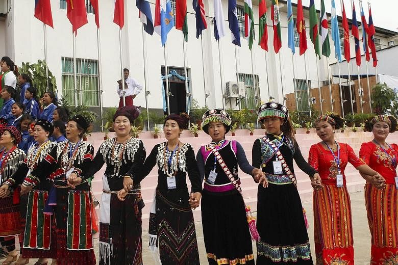 Women in Kachin ethnic traditional attire welcoming representatives of ethnic armed groups on the second day of the conference in Mai Ja Yang, Myanmar, yesterday.
