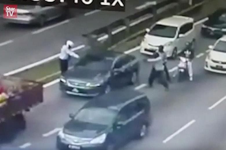 Video screenshots show four men on two motorcycles approaching the victim's car, which had stopped at a traffic light near Setapak Central mall in KL. Two of them fired the shots and they fled shortly after.