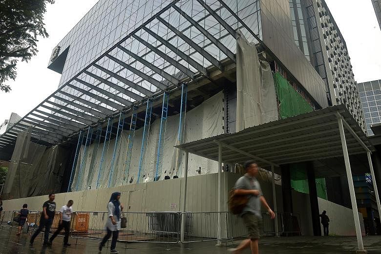 When The Straits Times visited the construction site at Knightsbridge mall (left) yesterday, the shop's interior was covered by construction canvas. However, tall glass structures were already in place, hinting at Apple's signature glass facade seen 