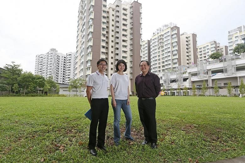 Ms Sun, flanked by grassroots leaders Derrick Teo (left) and Marc Tan, at the Punggol Walk site where the library will be built.