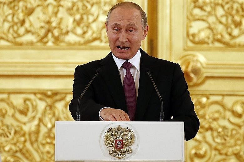 Russian President Vladimir Putin making a defiant speech in the Kremlin, saying the decision to ban Russian athletes was without basis and politically motivated.