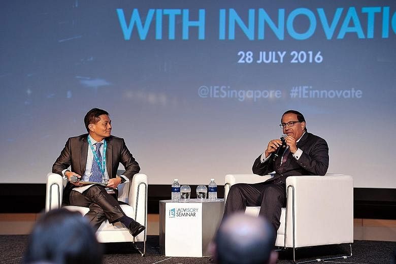 Mr Iswaran at the IE Singapore seminar with moderator Ang Ser Keng, senior lecturer in finance at the Lee Kong Chian School of Business, Singapore Management University.