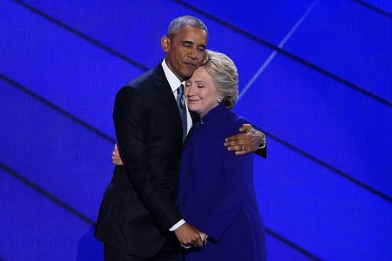 Mr Obama and Mrs Clinton, his bitter rival for the Democratic presidential nomination eight years ago, embracing each other on Wednesday.