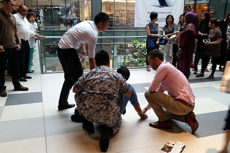 A 49-year-old man being held down by passers-by at Westgate after being spotted allegedly taking upskirt shots of a woman on an escalator at the neighbouring Jem mall.