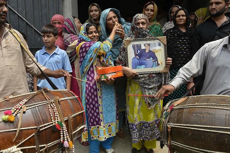 Relatives of Zulfiqar Ali celebrating in Lahore, Pakistan, yesterday after Indonesia halted the Pakistani national's execution. Ali was sentenced to death in 2005 for heroin possession.