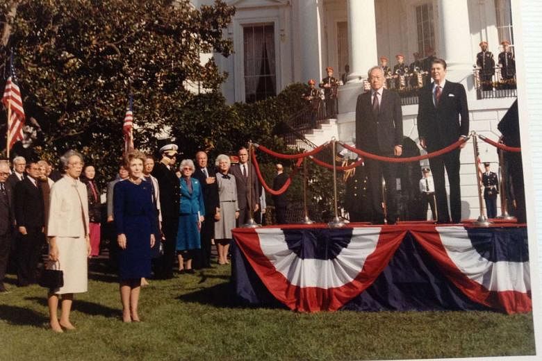 Then PM Lee Kuan Yew with then President Reagan at the ceremonial welcome on the White House lawn before the state dinner on Oct 8, 1985. With them are Mrs Lee, Mrs Reagan, then Secretary of State George Shultz (third from right on the lawn) and then Vice