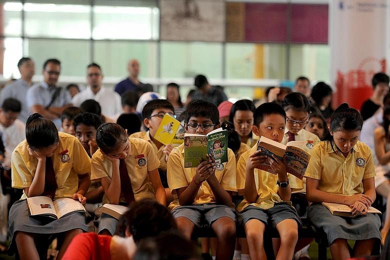 Pupils from Da Qiao Primary School at the National Library Building yesterday taking part in the Read For Books campaign, which sees one book donated to less privileged children for every 10 people who read for 15 minutes.