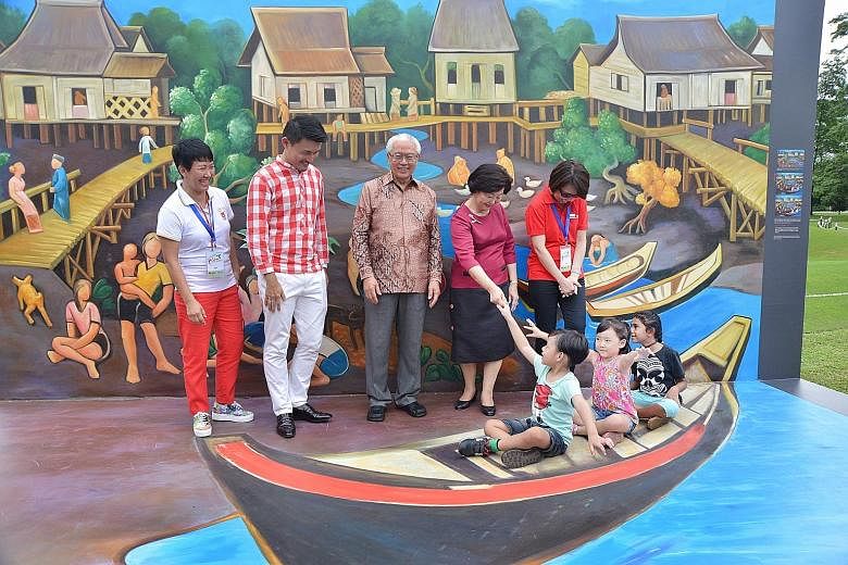 Three children in the same "boat" found themselves sharing the frame with President Tony Tan Keng Yam and his wife, Mary, in a photo booth at the Istana yesterday. Nuh Adam, five, Joan Ho, four and Zeenathunnisa, eight, were among the more than 15,00