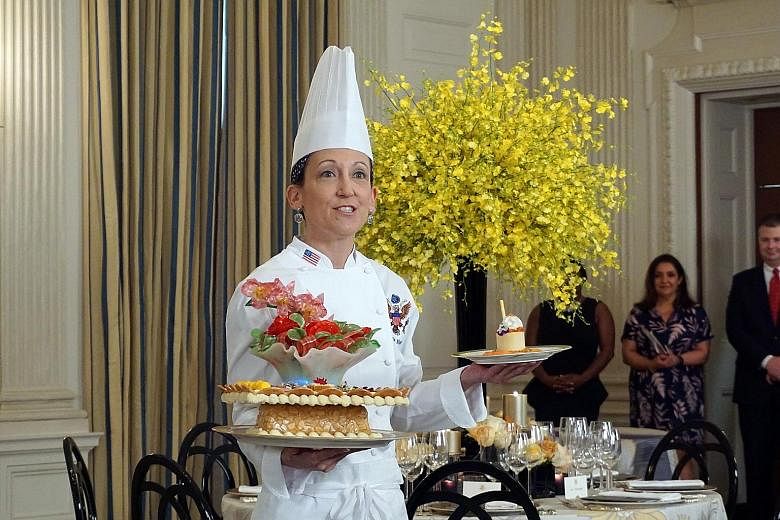 Executive pastry chef Susie Morrison with her desserts for the state dinner. Called "A Festive Gathering", the desserts have a motif of orchids and roses.
