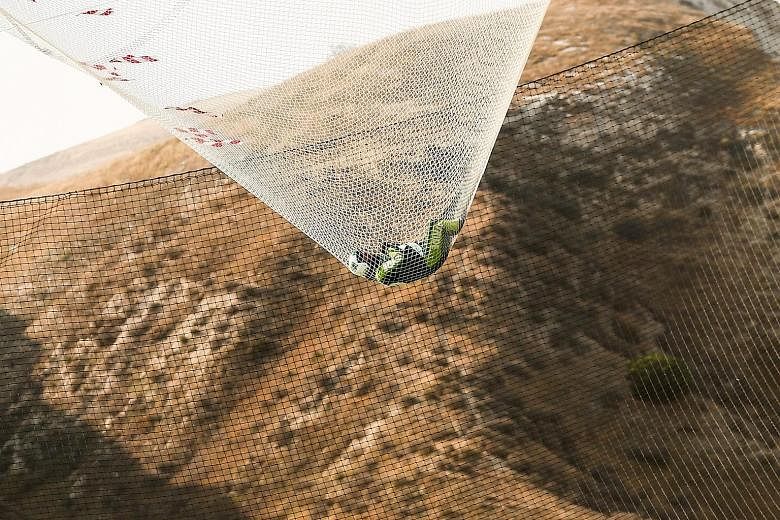 American skydiver Luke Aikins bouncing in a net that broke his fall after he jumped from an aeroplane flying at a height of more than 7,600m without a parachute or wing suit. His stunt in Simi Valley, California, last Saturday set a world record. SEE
