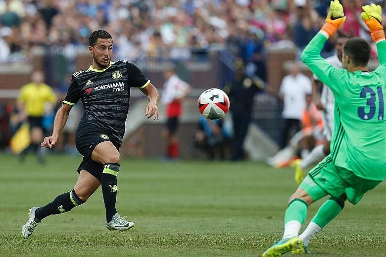 Chelsea forward Eden Hazard (left) shoots and scores against Real Madrid goalkeeper Ruben Yanez during an International Champions Cup friendly loss in Ann Arbor, Michigan. The Belgium international admits that Chelsea are tired after a week of manage