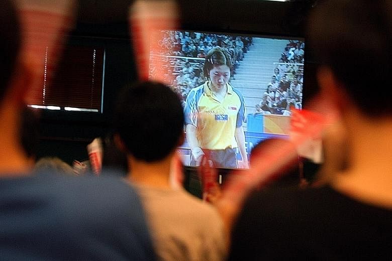 A crowd in Singapore watching as Li Jiawei attempts to win a table tennis bronze medal at the 2004 Athens Games. This month, Singaporeans will not be able to watch their compatriots compete 'live' at the Rio Games.