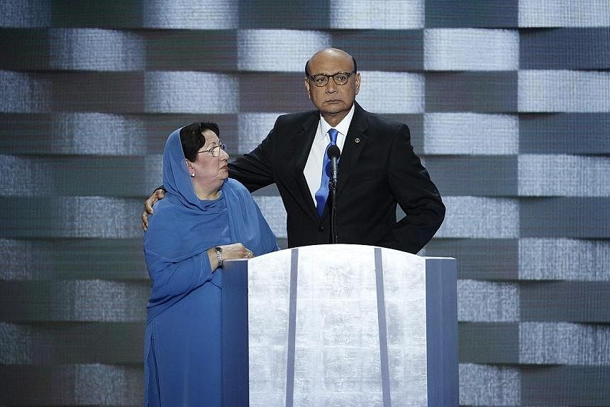 Mrs Khan on stage at the Democratic National Convention with her husband. Her silence was taken by Mr Trump as a sign of subservience.