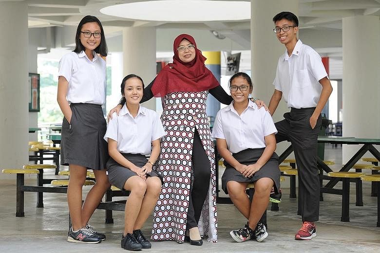 Madam Zainun Hashim, coordinator for the Malay Language Elective Programme, with four Pioneer Junior College students in the programme. They are (from left) Hanisah Syahirah Mohd Yani, 18; Nur Salina Rahmat, 19; Siti Rezkiah Mohd Radzelee, 17, and Mi