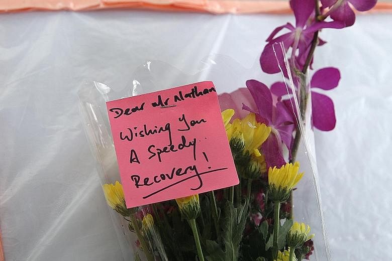 Visitors left flowers for Mr Nathan on a table outside SGH Block 5. He was hospitalised after a stroke on Sunday.