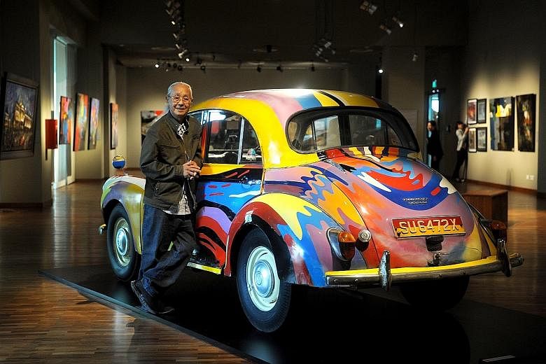 Chieu Shuey Fook with a 1961 Morris Minor which he was commissioned to paint for a charity auction. It is one of the exhibits at Art And Alchemy.