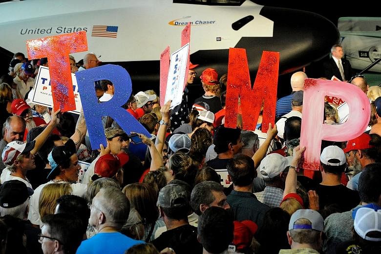 Trump supporters at the Wings Over the Rockies Air and Space Museum in Denver, Colorado, last Friday. Mr Trump appears to be caught in one of the biggest crises of his campaign.