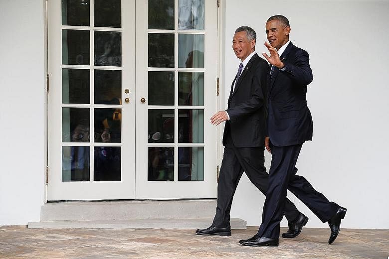 Clockwise from right: PM Lee and Mr Obama chatting in the Oval Office yesterday, acknowledging the crowd as they walked to their meeting at the White House, and taking the stage during the state arrival ceremony on the South Lawn yesterday. Some 2,00