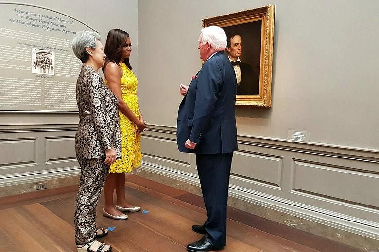 Mrs Lee and Mrs Obama on a tour of the National Gallery of Art in Washington, DC. The painting here is a portrait of the 16th US president Abraham Lincoln, the last painted depiction of him without a beard. Mrs Lee, Mrs Obama and Mrs Vivian Balakrish